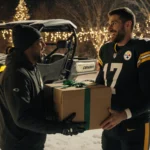 Aaron Rodgers handing a gleaming Can‑Am UTV to a shocked Steelers lineman with snow and holiday lights in the background