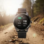 Amazfit Active Max sports watch rests on a worn outdoor trail with warm sunlight and a visible fitness tracking screen.