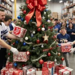 Angel Tree receives wrapped gifts with volunteers and smiling children watching