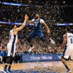 Anthony Davis leaping to high‑five a teammate with confetti swirling around and a cheering bench in the background