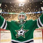Casey DeSmith celebrates victory with arms raised and confetti exploding behind him on the Dallas Stars goal