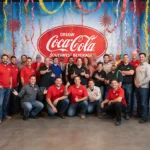Logistics team cheering with balloons and streamers at Coca‑Cola Truck Rodeo
