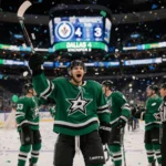 Dallas Stars player celebrating with teammates and confetti on a concourse scoreboard showing 4-3.