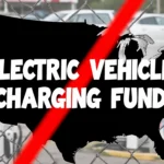 Dark US map shows a red slash and a white warning sign about electric vehicle charging funds with blurry cars behind.