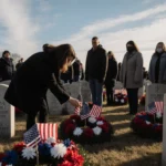 Woman placing a wreath on her father