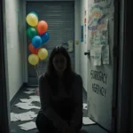 Woman sitting at surrogacy agency door with cold light illuminating her face and broken dreams littering hallway