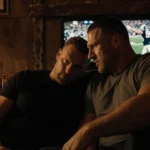 Rob Gronkowski a football legend sharing retirement advice speaking to Travis Kelce with worn leather couch and warm glow