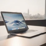 MacBook Air reflecting window light with minimalist desk and blurred cityscape outside