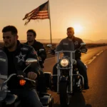 Four motorcyclists riding side by side with golden sunrise over desert road and fading flag.