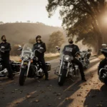 Four motorcycles with custom decals honoring Marshawn Kneeland parked on a sunlit highway oak trees riders stare up sadly