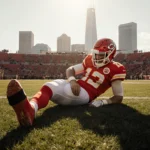Patrick Mahomes lying on grass clutching his knee with a torn ACL visible under a wrap and Kansas City skyline in soft light.