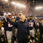 Patriots players huddle around coach with confetti and balloons in light fans leave disappointed