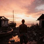 Wayuu community member standing on ruined fishing village shore with sunset sky and wrecked boat.