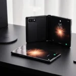 Samsung Galaxy Z Fold 6 unfurls with its display lighting and warm glow on a desk with wireless charging pad and headphones