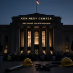 Kennedy Center façade glows with new Trump name installation under dark Washington D.C. sky and workers and blurred protester