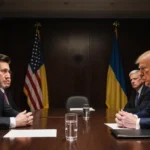 Zelenskyy and Trump sit across from each other with Ukrainian and American flags and a glass of water in diplomatic meeting