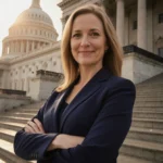 Abigail Spanberger stands with arms crossed at Virginia State Capitol with navy suit and golden dome light