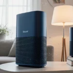 Blueair Blue Pure 311i Max air purifier positioned prominently with warm lamp light highlighting design and clean living room