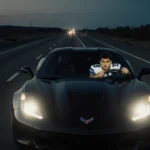 A sleek black sports car speeding down a dark tollway with a worried Cowboys player gesturing frantically in the passenger se