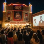 Crowd watching outdoor film at night with colorful festival lights and ornate wooden screen