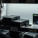 Disheveled retailer stands before empty shelf with scattered 16GB graphics cards and distant Nvidia GPU showing price