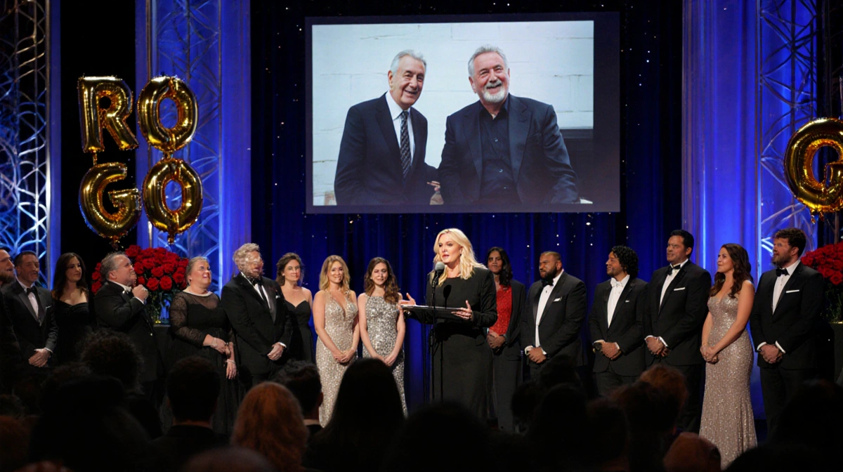Chelsea Handler delivering eulogy with a microphone and slideshow of Rob Reiner behind her in a room with red roses.