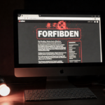 LED light flickers over a computer screen showing a forbidden webpage with deep gray background and faint red glow.