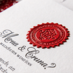 Wedding invitation is stamped with a raised red seal and elegant calligraphy on a soft‑focus white background