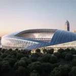 Futuristic domed stadium glows with LED lights and translucent roof while rising near city skyscrapers and green parkland