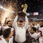 Indiana Hoosiers hoisting trophy with confetti and coach Curt Cignetti celebrating college football championship