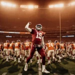 Indiana quarterback throws victory pass with teammates celebrating and empty Miami bench showing 0-10 defeat