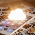 Cluttered iPhone screen displaying overlapping apps and scattered photo thumbnails with faint iCloud glow and storage clutter