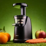 Juicer arranging fresh orange apple carrot on green background with warm healthy light