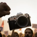 Leica camera flying through air with protester