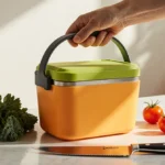 Meal prep box sits on kitchen counter with fresh kale cherry tomatoes and a gleaming Zwilling knife