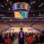 Fans cheer in orange and purple seats with Miami stadium logo and confetti filling the arena