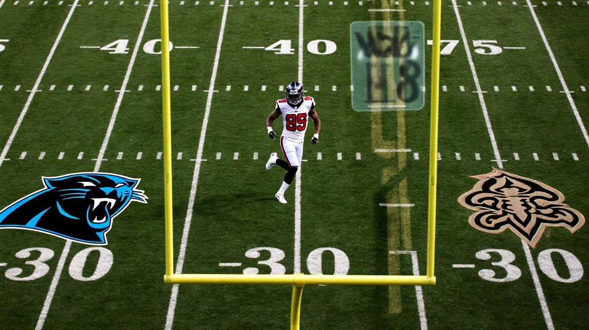 Panthers player kicking on field with NFC South logos on goalposts and Falcons sprinting toward goalposts in background