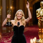 Nikki Glaser holds Golden Globe award with bright smile at Beverly Hilton podium