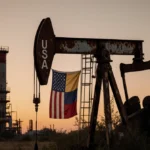 Flags drape from rusty oil derrick with crumbling refinery equipment and overgrown vegetation.