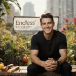 RFK Jr. sits on wooden bench with protein bars and Endless Protein banner behind him