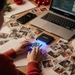 Glowing Samsung SSD organizing holiday photos on cluttered desk with laptop and phone near notes