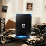 Sleek Samsung SSD glowing with natural light on a cluttered desk with old storage and dusty files.