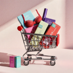 Shopping cart overflowing with colorful lingerie and intimate accessories with pastel pink background and warm lighting