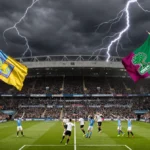 Fans cheering in packed stadium with yellow and blue Villa flags and green Forest flags under lightning sky.