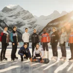 Winter Olympic athletes standing together on ice with Italian Alps reflected behind them showing unity and achievement